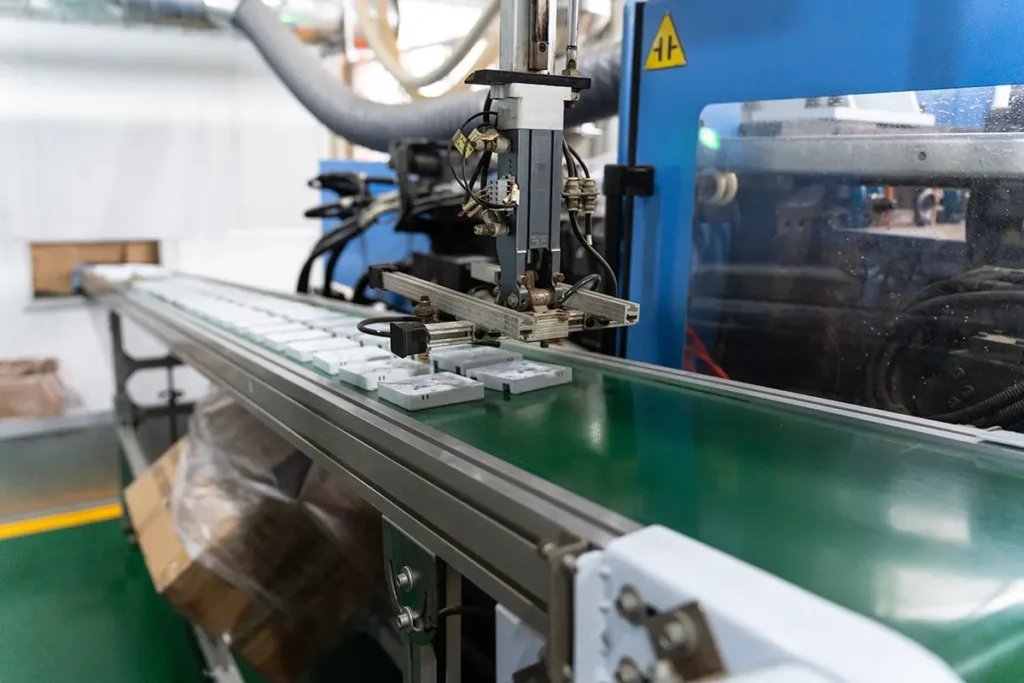 Injection molding production line for fiber optic outlet boxes