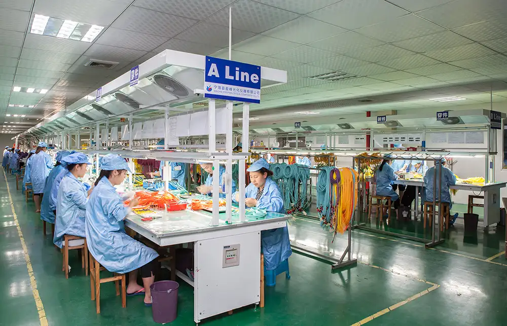 Workers assembling fiber optic patch cords at Yingfeng’s workshop