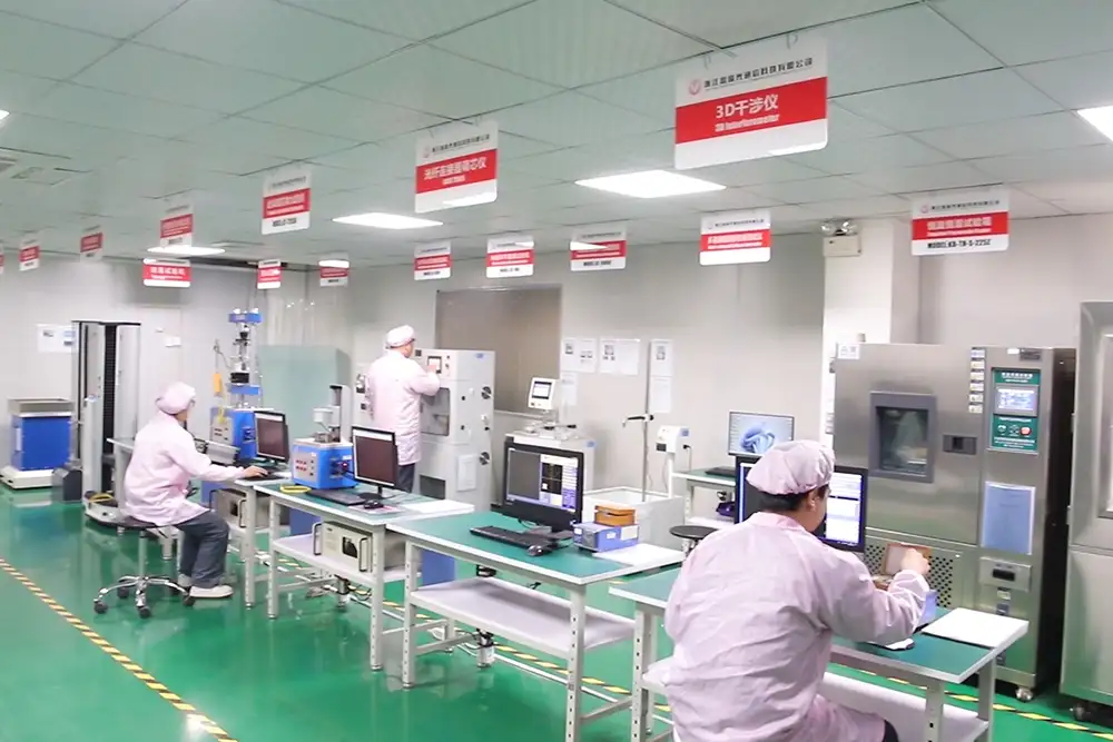Technician performing quality testing on fiber optic products in factory lab